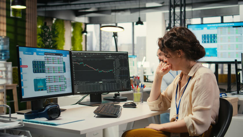 Business-Class Secrets You Won’t Find on Booking Sites 5 financial analyst working at computer with trading charts Business-Class Secrets You Won’t Find on Booking Sites