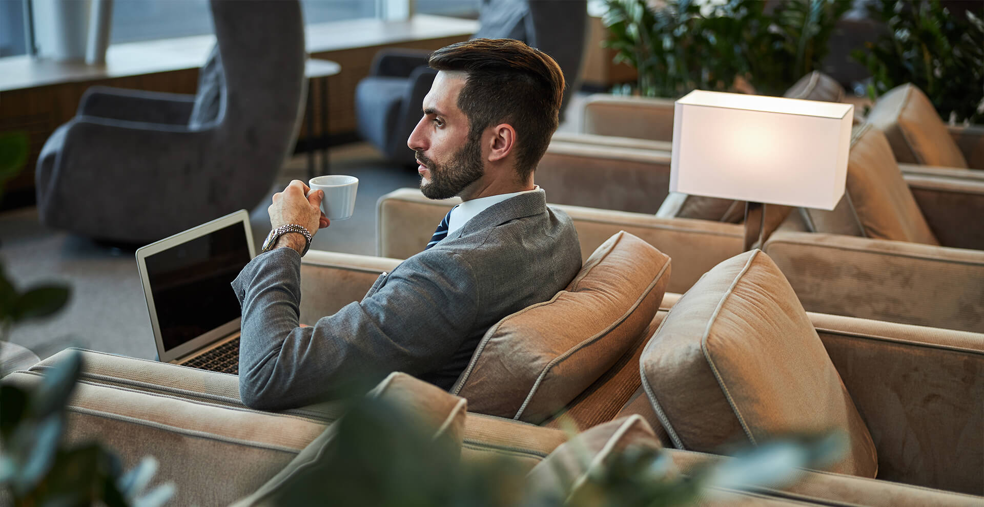 businessman working on laptop in modern lounge 6 Travel Habits for a Better 2026