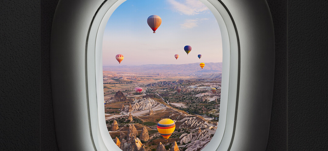 Sleeping in a cave in Cappadocia: how the room you book changes the experience 5 airplane window view of cappadocia hot air balloons